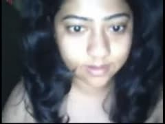 An amateur Indian webcam model plays with her natural breasts.